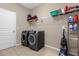 Laundry room with washer, dryer, and ample storage shelving at 8060 Bowery Dr, Winter Garden, FL 34787