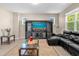 Spacious living room with sectional sofa and large TV at 8060 Bowery Dr, Winter Garden, FL 34787