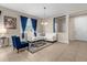 Spacious living room featuring a white sectional sofa and blue accents at 8060 Bowery Dr, Winter Garden, FL 34787