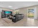 Spacious living room with leather sectional sofa and large TV at 8060 Bowery Dr, Winter Garden, FL 34787