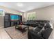 Living room features a sectional sofa, large TV, and access to backyard at 8060 Bowery Dr, Winter Garden, FL 34787
