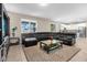 Open living room with sectional sofa and views into kitchen area at 8060 Bowery Dr, Winter Garden, FL 34787