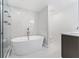 Luxurious bathroom with soaking tub, marble shower, and modern vanity at 851 Marllo Rd, Kissimmee, FL 34744