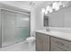 Updated bathroom with gray vanity, quartz countertop, and glass shower at 851 Marllo Rd, Kissimmee, FL 34744