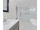 Spa-like bathroom with soaking tub, large shower, and marble tile at 851 Marllo Rd, Kissimmee, FL 34744