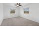 Well-lit bedroom with ceiling fan and neutral carpeting at 851 Marllo Rd, Kissimmee, FL 34744