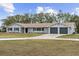 Ranch style home with gray exterior, two-car garage, and landscaped yard at 851 Marllo Rd, Kissimmee, FL 34744