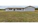 Gray house exterior with large backyard at 851 Marllo Rd, Kissimmee, FL 34744