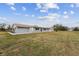 Gray house exterior with large backyard at 851 Marllo Rd, Kissimmee, FL 34744