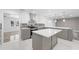 Modern kitchen with gray and white cabinets and a large island at 851 Marllo Rd, Kissimmee, FL 34744
