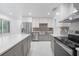 Updated kitchen featuring stainless steel appliances and a farmhouse sink at 851 Marllo Rd, Kissimmee, FL 34744
