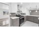 Modern kitchen with gray cabinets, stainless steel appliances, and quartz countertops at 851 Marllo Rd, Kissimmee, FL 34744