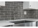 Sleek kitchen sink and faucet with gray tile backsplash at 851 Marllo Rd, Kissimmee, FL 34744