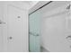 Updated shower with frameless glass enclosure and marble tile at 851 Marllo Rd, Kissimmee, FL 34744