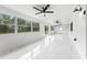 Bright sunroom features tile flooring, multiple ceiling fans, and large windows at 851 Marllo Rd, Kissimmee, FL 34744