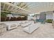 Relaxing outdoor lounge area with white wicker furniture under a pergola at 8714 Sonoma Coast Dr, Winter Garden, FL 34787