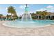 Resort-style pool with fountain, plenty of lounge chairs, and palm trees at 8714 Sonoma Coast Dr, Winter Garden, FL 34787