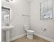 Clean powder room featuring a pedestal sink and toilet at 8714 Sonoma Coast Dr, Winter Garden, FL 34787