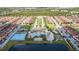 Aerial view of community with pools, tennis courts, and numerous homes at 8956 California Palm Rd, Kissimmee, FL 34747