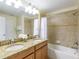 Bathroom features granite countertops, double sinks, and bathtub at 8956 California Palm Rd, Kissimmee, FL 34747