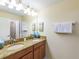 Bathroom with double sinks and granite countertop at 8956 California Palm Rd, Kissimmee, FL 34747