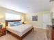 Spacious Primary bedroom with king-size bed and en-suite bathroom at 8956 California Palm Rd, Kissimmee, FL 34747