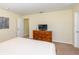 Bedroom with dresser, TV, and comfortable bed at 8956 California Palm Rd, Kissimmee, FL 34747