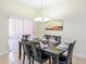 Dining room with dark wood table, chairs and chandelier at 8956 California Palm Rd, Kissimmee, FL 34747