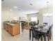 Open concept kitchen and dining room with granite counters and wood cabinets at 8956 California Palm Rd, Kissimmee, FL 34747