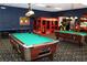 Game room featuring pool tables, arcade games, and a play area at 8956 California Palm Rd, Kissimmee, FL 34747