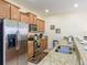 Modern kitchen with stainless steel appliances and granite countertops at 8956 California Palm Rd, Kissimmee, FL 34747