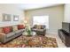 Living room with gray couches, coffee table, and patterned rug at 8956 California Palm Rd, Kissimmee, FL 34747