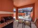 Private patio with pool, table, chairs, and grill at 8956 California Palm Rd, Kissimmee, FL 34747