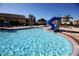 Relaxing community pool with a waterslide at 8956 California Palm Rd, Kissimmee, FL 34747