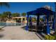 Cabana and lounge chairs around a refreshing community pool at 8956 California Palm Rd, Kissimmee, FL 34747
