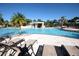 Resort-style pool with waterfall feature and lounge chairs at 8956 California Palm Rd, Kissimmee, FL 34747