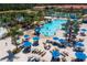 Large community pool with a water slide and lounge area at 8956 California Palm Rd, Kissimmee, FL 34747