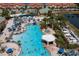 Large community pool with a water slide and hot tub at 8956 California Palm Rd, Kissimmee, FL 34747