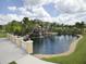 Serene pond with a waterfall and walking path at 8956 California Palm Rd, Kissimmee, FL 34747