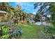Landscaped backyard with lake view at 1115 Lake Nettie Dr Dr, Eustis, FL 32726