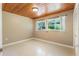 Bright bedroom with wood ceiling featuring natural light from the windows at 1115 Lake Nettie Dr Dr, Eustis, FL 32726