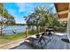 Lakefront deck with lounge chairs and table at 1115 Lake Nettie Dr Dr, Eustis, FL 32726