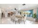 Sun-filled dining area featuring a modern table and lake views at 1115 Lake Nettie Dr Dr, Eustis, FL 32726