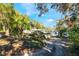 Charming single-story home surrounded by mature trees on a sunny day at 1115 Lake Nettie Dr Dr, Eustis, FL 32726