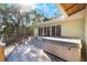 Relaxing deck with hot tub overlooking tranquil scenery at 1115 Lake Nettie Dr Dr, Eustis, FL 32726