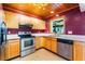 Kitchen with wood cabinets and stainless steel appliances at 1115 Lake Nettie Dr Dr, Eustis, FL 32726