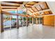 Bright living room boasts wood ceiling, tile floor, and lake views at 1115 Lake Nettie Dr Dr, Eustis, FL 32726