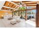 Living room features a wood ceiling, sliding glass doors to the balcony, and a lake view at 1115 Lake Nettie Dr Dr, Eustis, FL 32726
