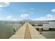 Lakefront dock with a covered gazebo and benches at 12795 Trovita Dr, Grand Island, FL 32735