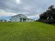 House on a large lot with a lush green lawn and surrounding trees at 1445 Olympic Club Blvd, Champions Gate, FL 33896